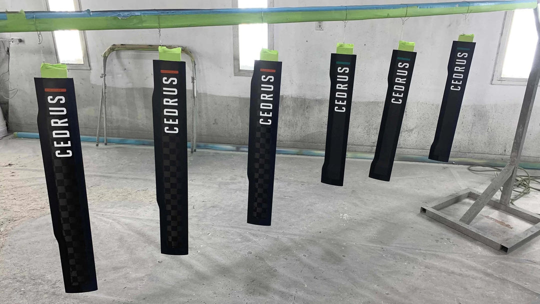 A small batch of six Cedrus masts in the manufacturing process showcasing that Cedrus masts are custom made in small batches to reduce waste and strain on the environment.