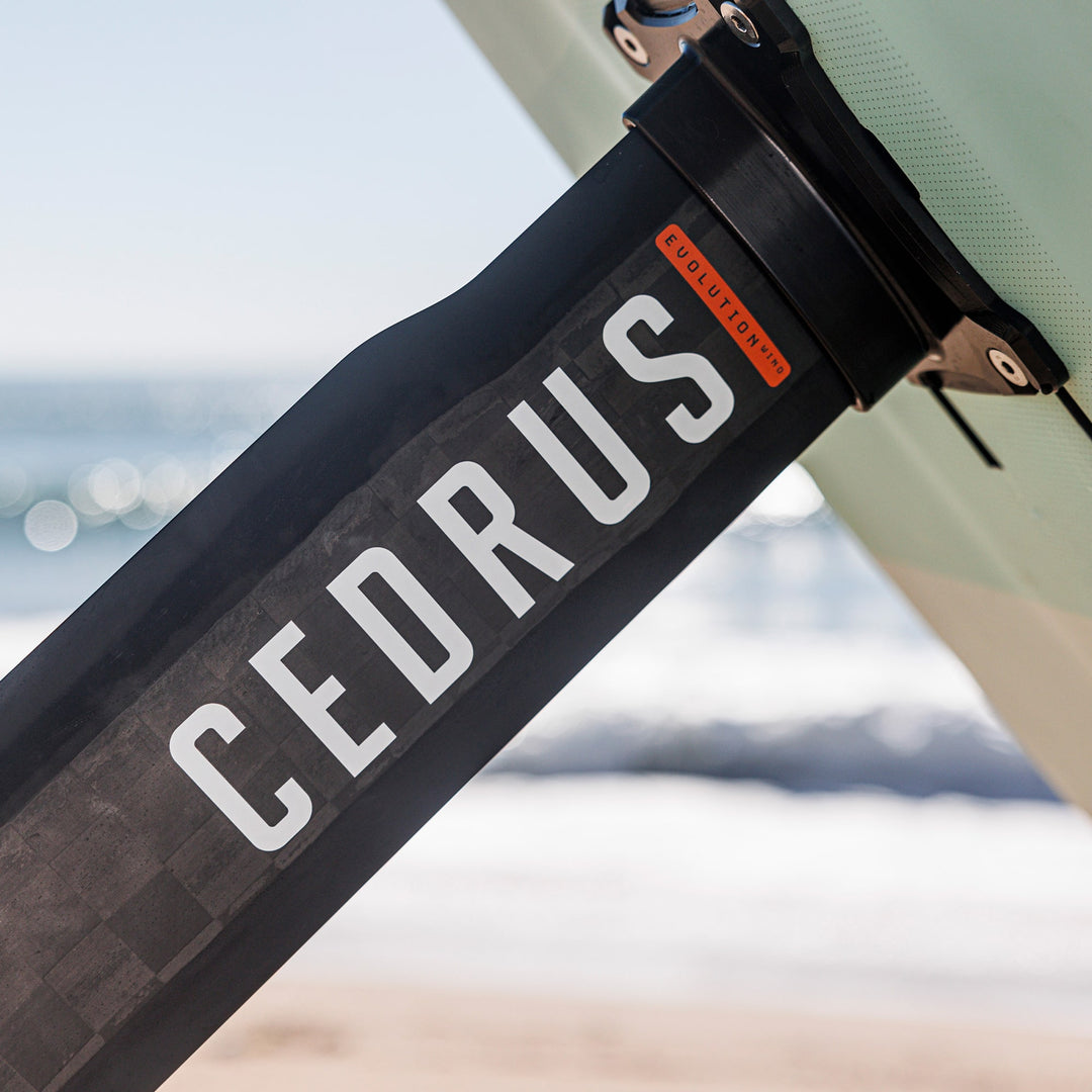 A close-up view of a mounted Cedrus Evolution Wind mast reveals the intricately carbon fiber and the unmistakable branding that marks its quality and design sophistication